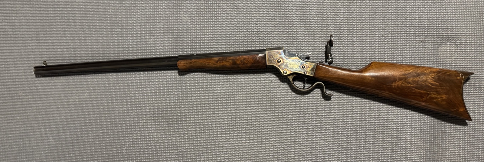 Stevens 44 heavy Schuetzen rifle from the other side, showing the case-colored frame, spur lever, and tang peep sight