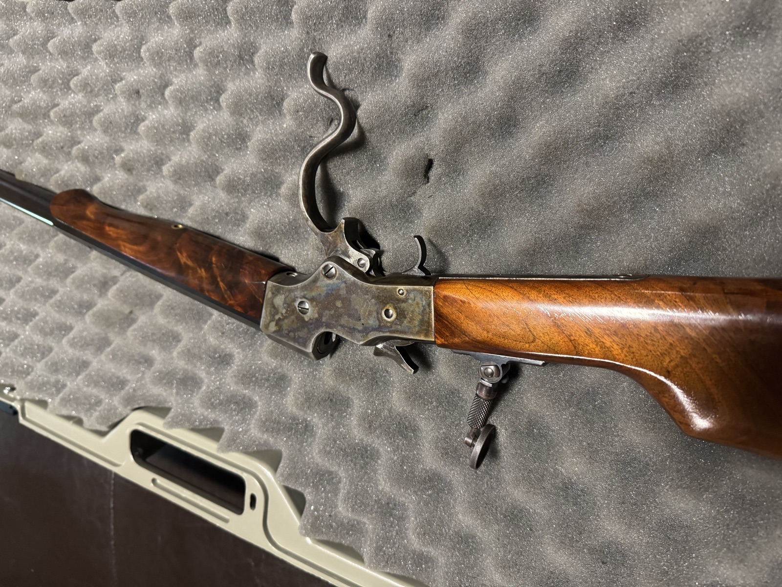 Side view of the Stevens 44 with the lever dropped and action open, showing case colors on the frame and the figured walnut of forend and butt