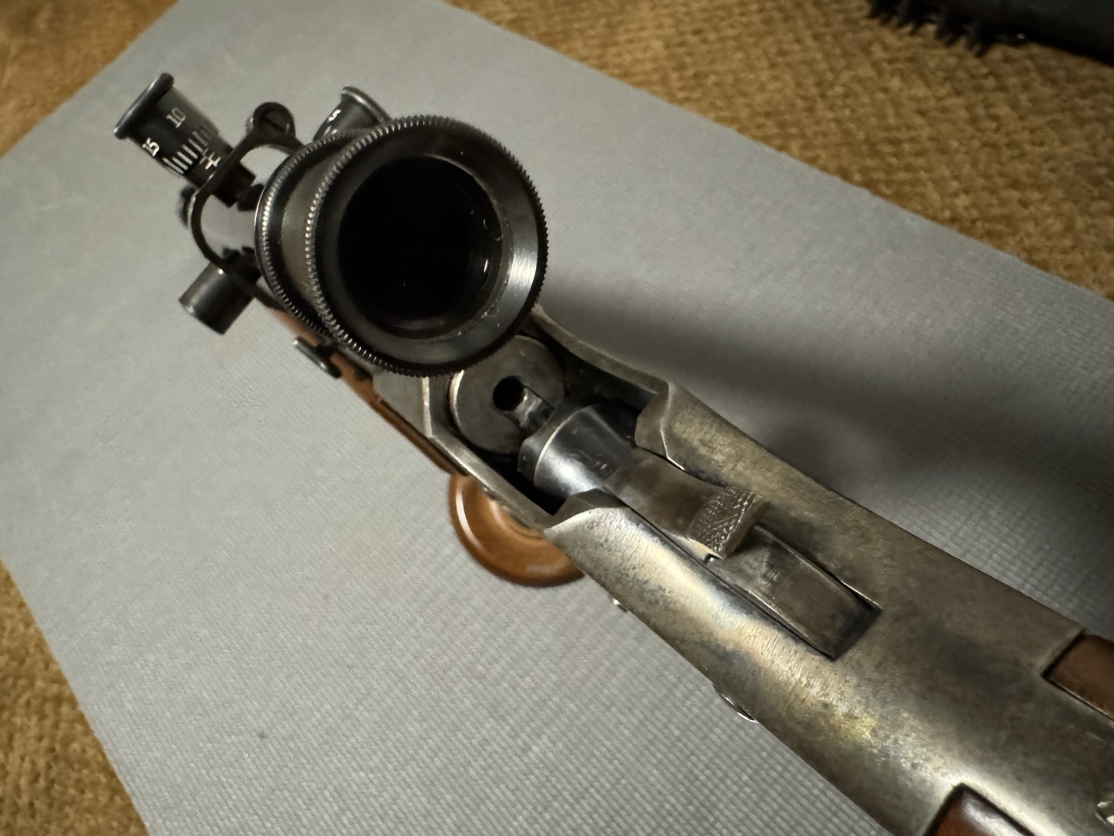 Looking down into the open breech of the Stevens 44½ from behind the scope eyepiece, block down and extractor exposed