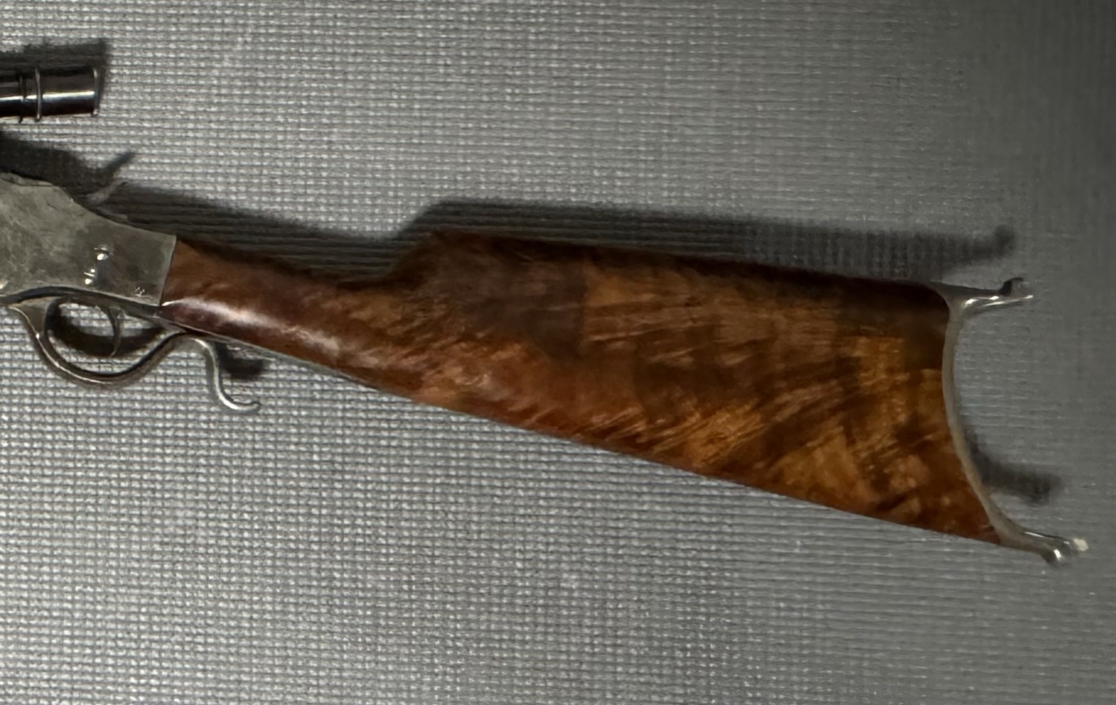 Close view of the Stevens 44½ buttstock: figured walnut, straight wrist, and hooked Swiss buttplate